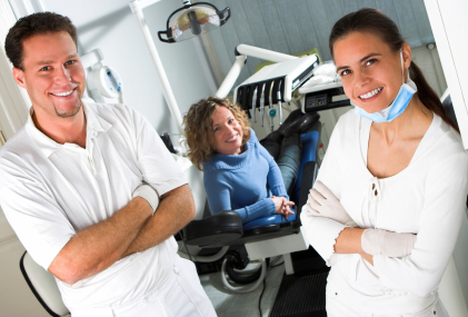 smiling staff members with patient