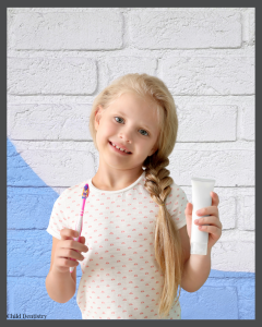 young girl with toothbrush and toothpaste