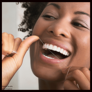 a girl flossing her teeth